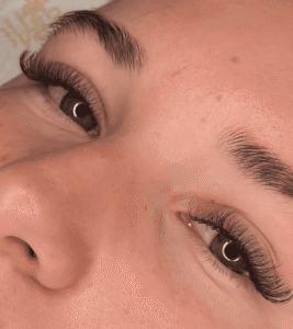 Close-up of person's eyes with eyelash extensions.