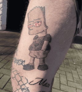 Cartoon character tattoo on person's leg.