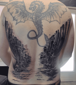 Dragon and ruins tattoo on back