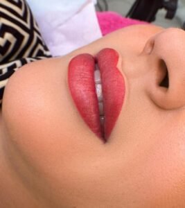 Close-up of lips with red lipstick.