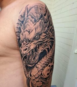 Detailed dragon tattoo on a person's arm.