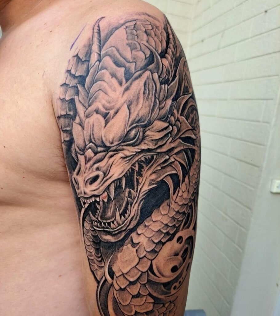 Detailed dragon tattoo on a person's arm.