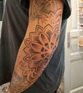 Arm tattoo featuring intricate floral design